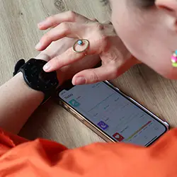 Woman downloading the OmniWatch app as the first step in setting up her new health companion.